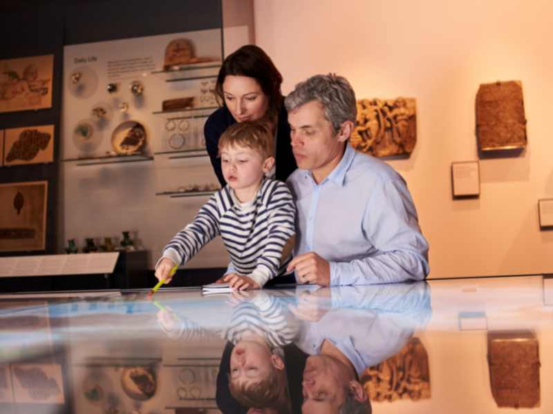 family looking at a museum case