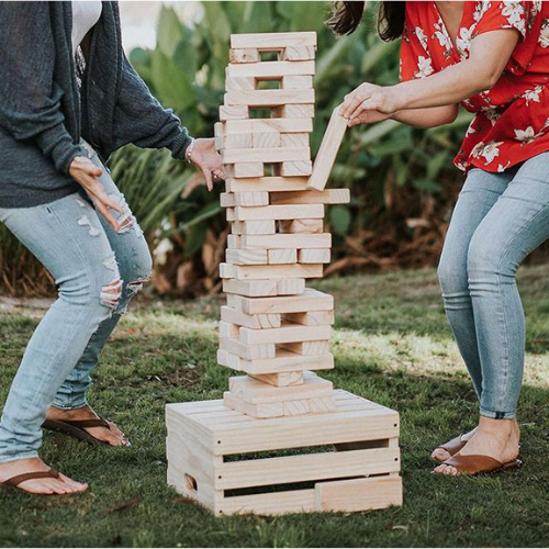 Couple playing giant jenga.
