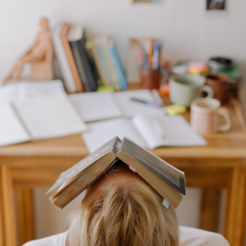 person with book on face