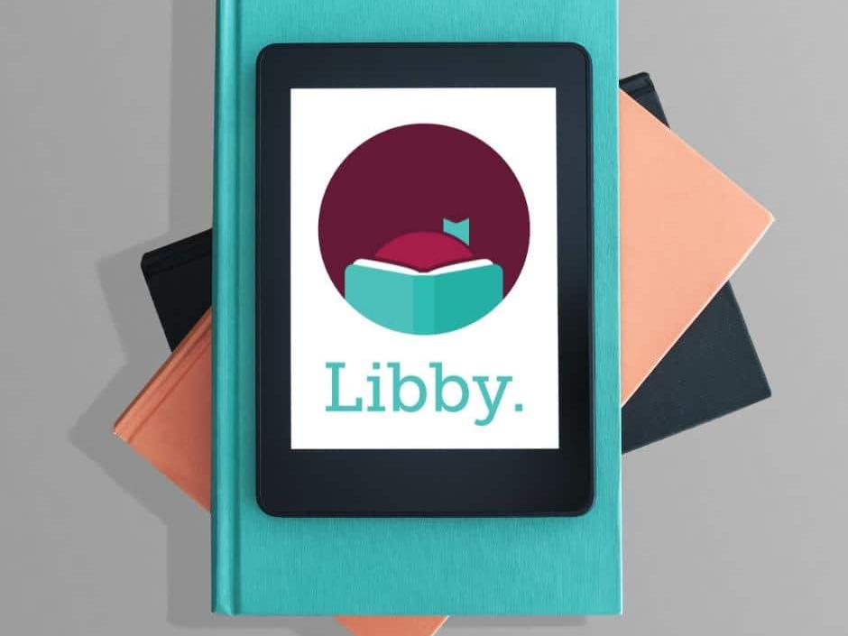 Books with tablet with Libby Logo on it.