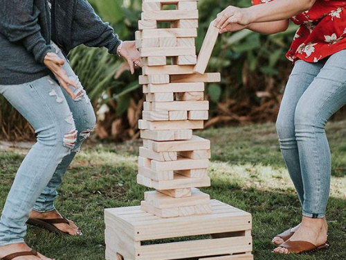 Couple playing giant jenga.